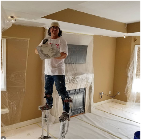 An image of a ceiling specialist working on a project